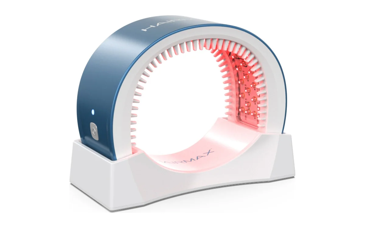 HairMax LaserBand 82 laser band in its charging cradle