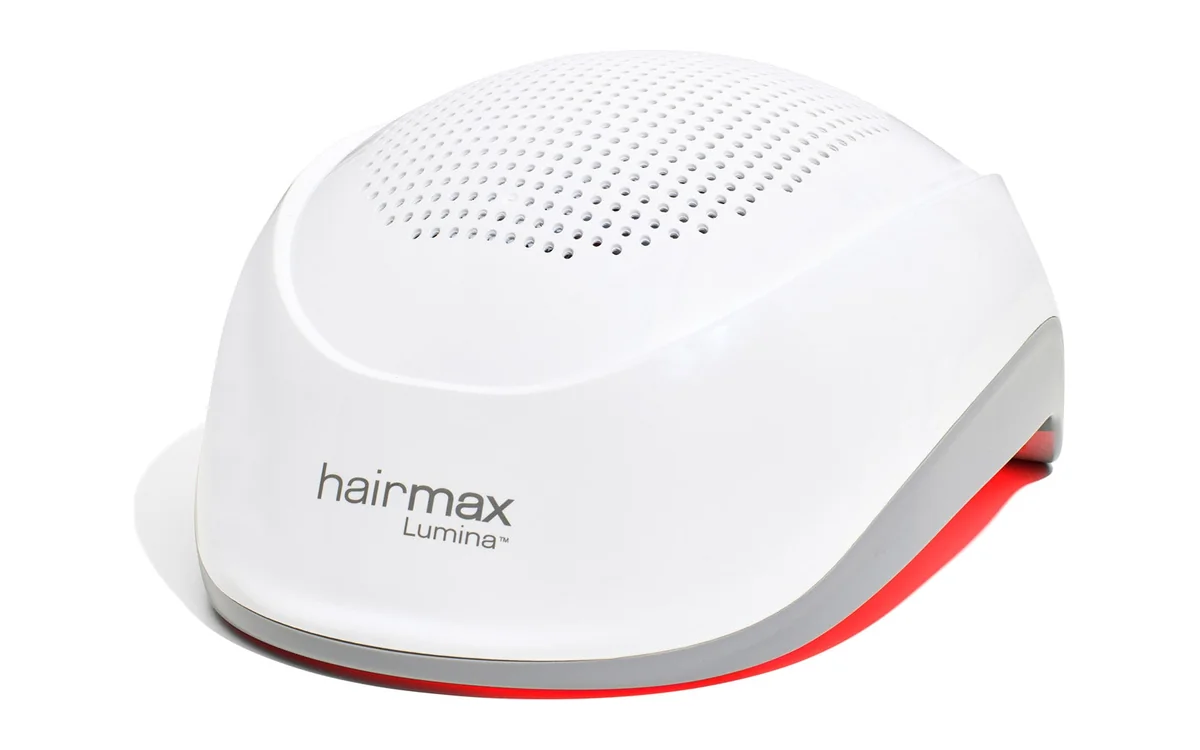 HairMax Lumina cordless laser hair growth helmet with red lasers glowing at the rim