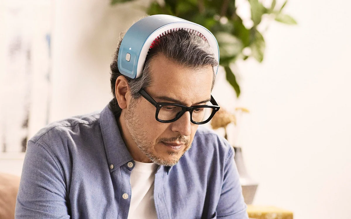 HairMax review: a man using the HairMax LaserBand 82 laser band at home